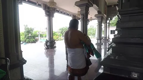 Hindu Priest prepares for ritual inside Temple, Batu caves, Kuala Lumpur Stock Footage 186554129