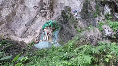 Hindu statues at limestone cliff wall, Main Temple cave, Batu caves, Malaysia Stock Footage 196369187
