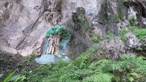 Hindu statues at limestone cliff wall, Main Temple cave, Batu caves, Malaysia Stock Footage 196369447