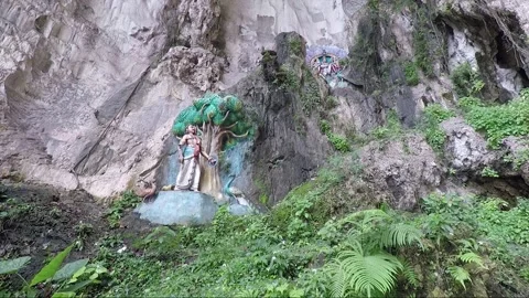 Hindu statues at limestone cliff wall, Main Temple cave, Batu caves, Malaysia Stock Footage 196369586