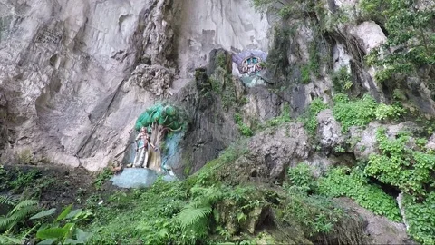 Hindu statues at limestone cliff wall, Main Temple cave, Batu caves, Malaysia Stock Footage 196382617