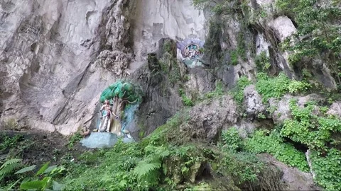 Hindu statues at limestone cliff wall, Main Temple cave, Batu caves, Malaysia Stock Footage 196383069