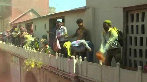Hindu widows throw flower petals and colored powder during Holi celebrations . Stock Footage 196238203