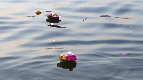 Hinduism religious ceremony puja flowers and candle on the sacred river Ganges Stock Footage