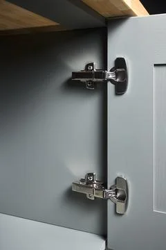 Hinge cabinet of kitchen moss grey cupboard door metal furniture isolated under Stock Photos