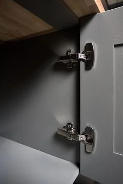 Hinge cabinet of kitchen moss grey cupboard door metal furniture isolated under Stock Photos