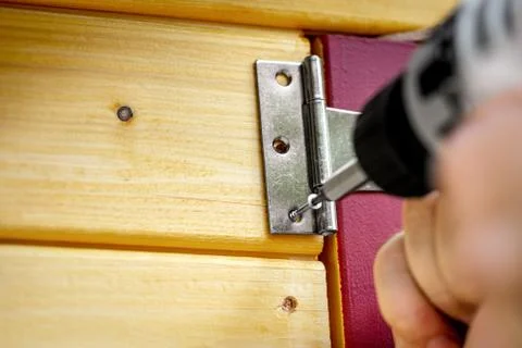 Hinge Door fitting or cross hanger is screwed to a door 스톡 사진