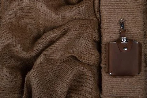 Hip flask in leather case on burlap Stock Photos