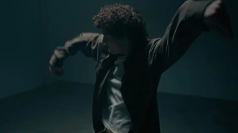Hip Hop Dance Battle of Young Man and Woman in Dark Studio Stock Footage 335680945