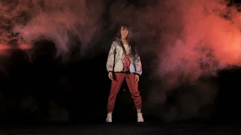 Hip hop dancer actively moving in puffs of smoke Video stock 134780372