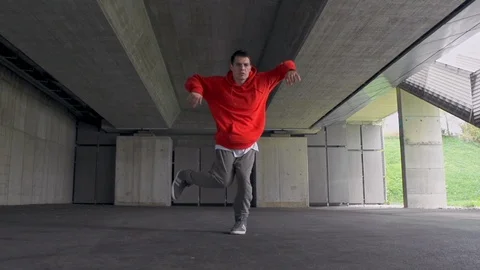 Hip-Hop Dancer Doing Some Moves In Front Of The Big Building Stock Footage 87710721