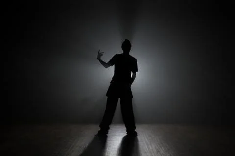 Hip-hop dancer posing backlit. Stock Photos