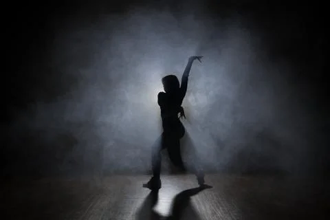 Hip-hop dancer posing backlit. Stock Photos