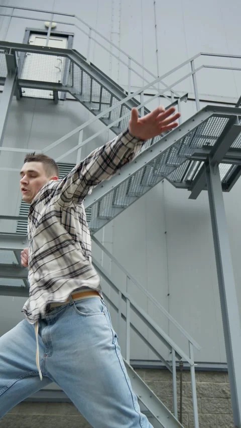 Hip hop dancer practicing dance routine performing freestyle moves in city. Stock Footage 308806241