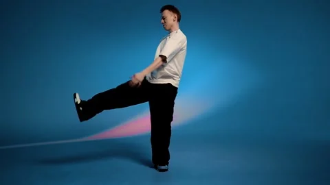 Hip hop dancer twisting in a wide squat with powerful rhythm Stock Footage 345602659