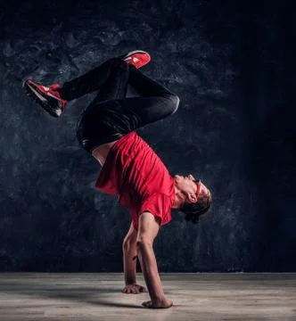 Hip-hop style dancer performs breakdance acrobatic elements. Stock Photos