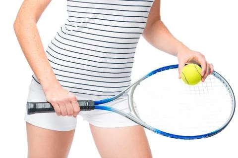 At the hip level, hands with a racket and a tennis ball close-up Stock Photos