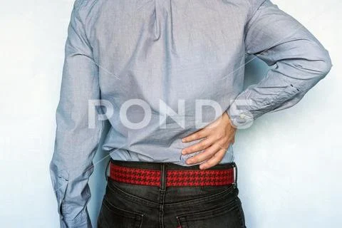 Hip or back injury. Young man touching his hurt right side of body. Stock Photos