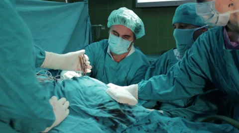 Hip surgery. Surgeons team performing operation in hospital operating room. Stock Footage 34630113