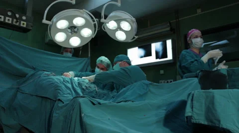 Hip surgery. Surgeons team performing operation in hospital operating room. Stock Footage