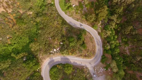 Hippie Mini Van Driving on the Road Through Hills Nature Aerial Drone View Vídeo Stock 128485591