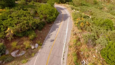 Hippie Mini Van Driving on the Road Through Hills Nature Aerial Drone View Vídeo Stock 128485957