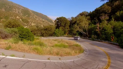 Hippie Mini Van Driving on the Road Through Hills Nature Aerial Drone View 動画素材 128485971