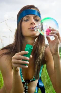 Hippy blowing soap bubbles Stock Photos