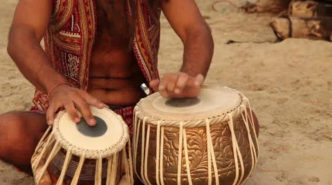 Hippy play on the drum and sit on the beach Stock Footage 26322093