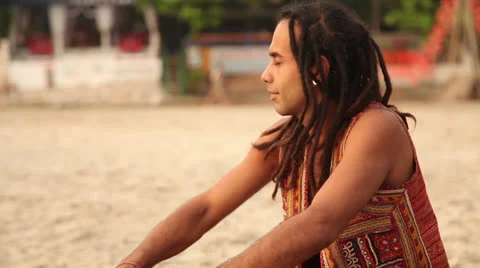 Hippy play on the drum and sit on the beach Stock Footage 26322193