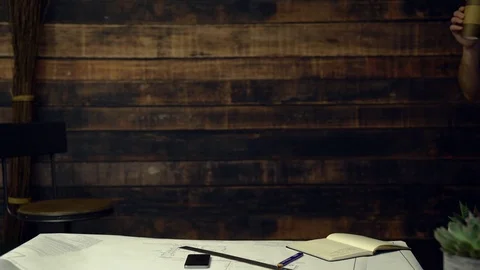 Hipster architect drinking coffee takes notes Stock Footage 85427824
