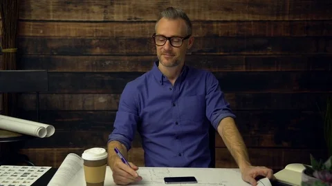 Hipster architect drinks coffee and smiles Stock Footage 85431323