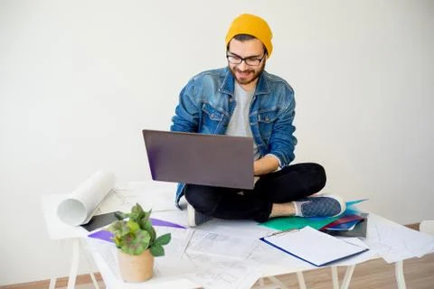 Hipster architect working with construction plans Stock Photos