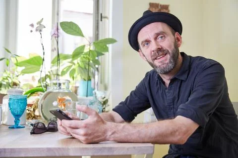 Hipster with beard and hat looking to camera Stock Photos