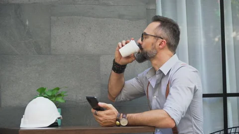 Hipster bearded man take a break  using phone and drinking coffee at coffee s Stock Footage 155221721