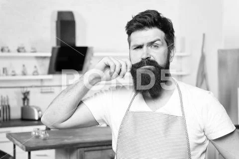 Hipster bearded masculine chef cooking food in kitchen. Cuisine for real men Stock-Fotos