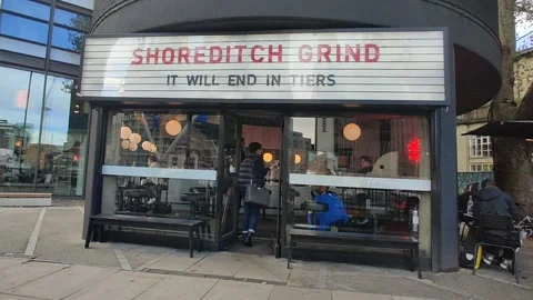 HIPSTER CAFE 'IT WILL END IN TIERS' REFERRING TO THE THREE TIER STRATEGY UK 4K Stock Footage 143122644