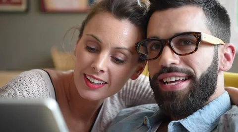 Hipster couple having fun using digital tablet Stock Footage 64760756