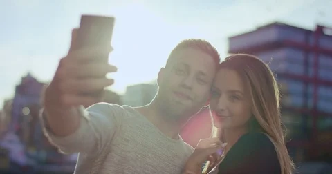 Hipster couple taking selfie in front of Hafencity Stock Footage 79389013