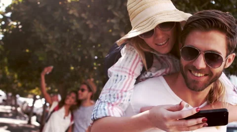 Hipster couple taking selfie while doing piggy back Stock-Footage 59698124