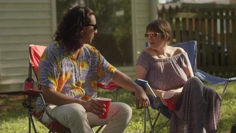 Hipster couples sit around a fire pit in the backyard while having drinks Video stock 116801798
