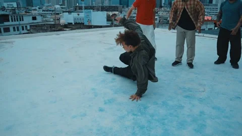 Hipster doing freeze pose while moving footstep to music at rooftop. hiphop. Stock Footage 257996372