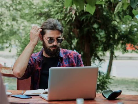 Hipster doing homework in a cafe Stock Photos