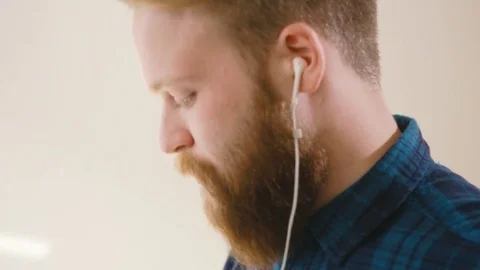 Hipster drinking coffee at desk in creative office Stock Footage 76484183