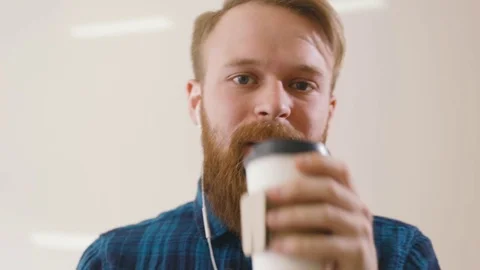 Hipster drinking coffee at desk in creative office Stock Footage 76485239
