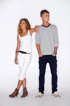 Hipster fashion. Hipster male and female standing in a studio and both looking Stock Photos