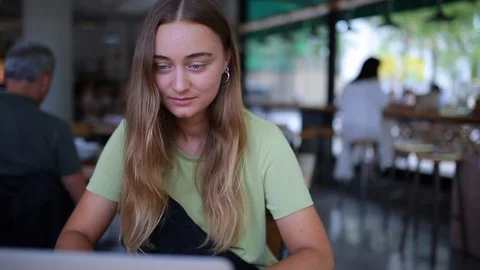 Hipster female writes notebook study distance or work as freelancer 動画素材 127695321