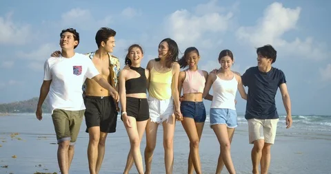 Hipster Friends walking down the beach with happy emotion. People with party cel Video stock 104990873