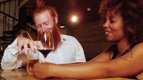Hipster with a ginger beard flirts with a very beautiful cheerful black woman in Stock Footage 68570937