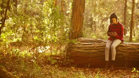 Hipster girl using digital tablet in the forest. Handheld shot Stock Footage 47318251